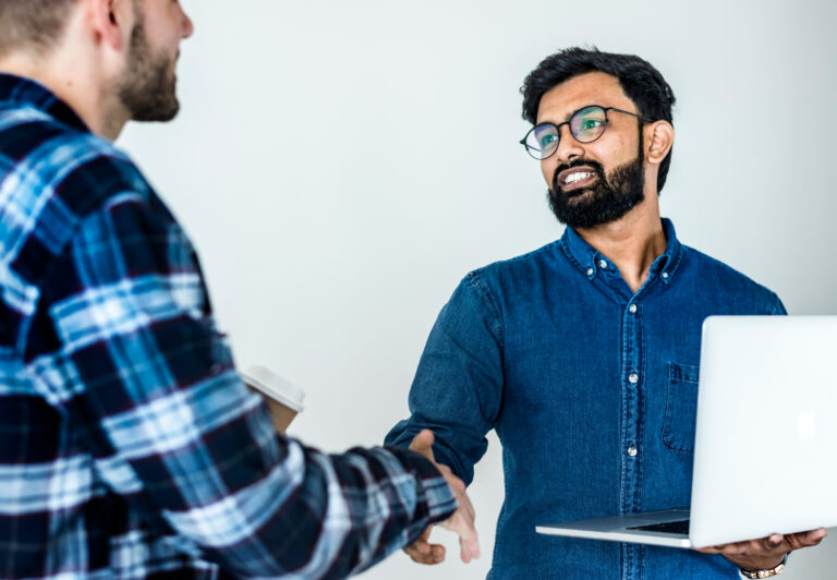 diverse-colleague-men-shaking-hands-together